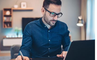 Man using a laptop at home. 