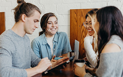 Group of young people sitting together at a table