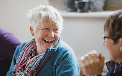 Two women in conversation, smiling